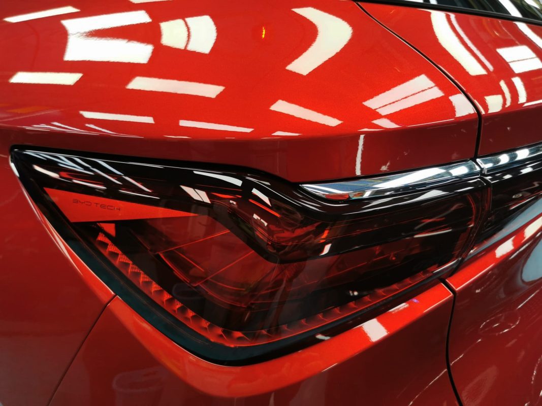 The coated bonnet of the BYD Atto 3 under workshop lighting.