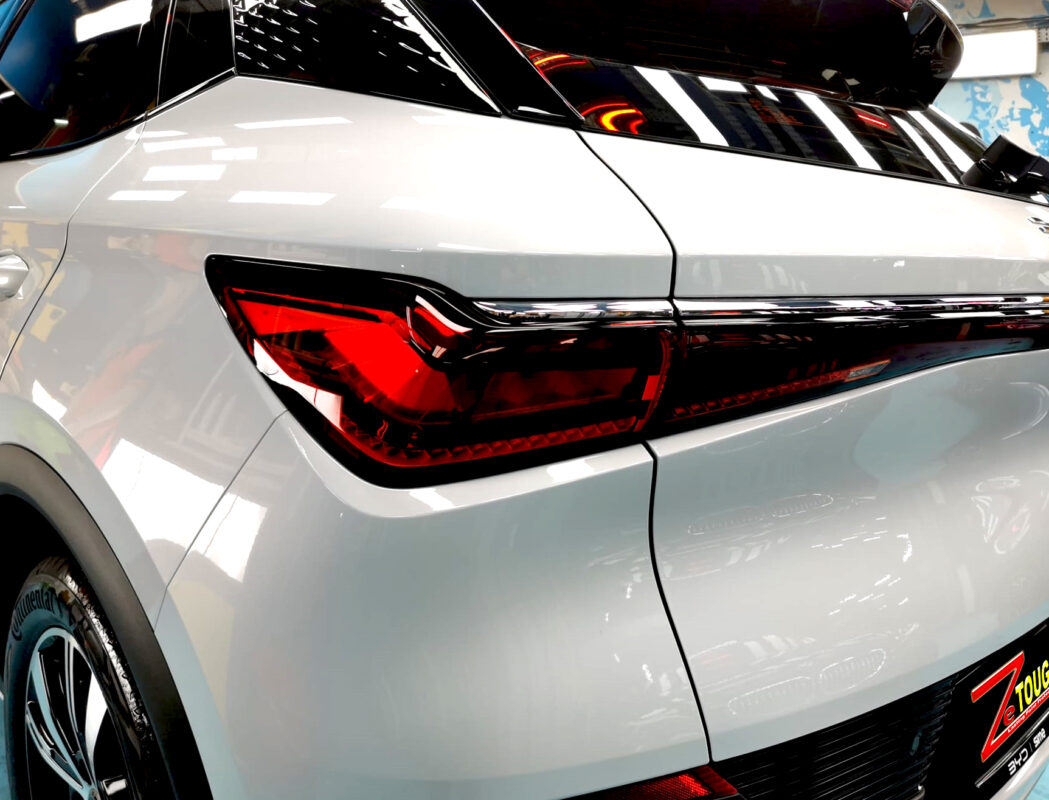 The coated bonnet of the BYD Atto 3 under workshop lighting.