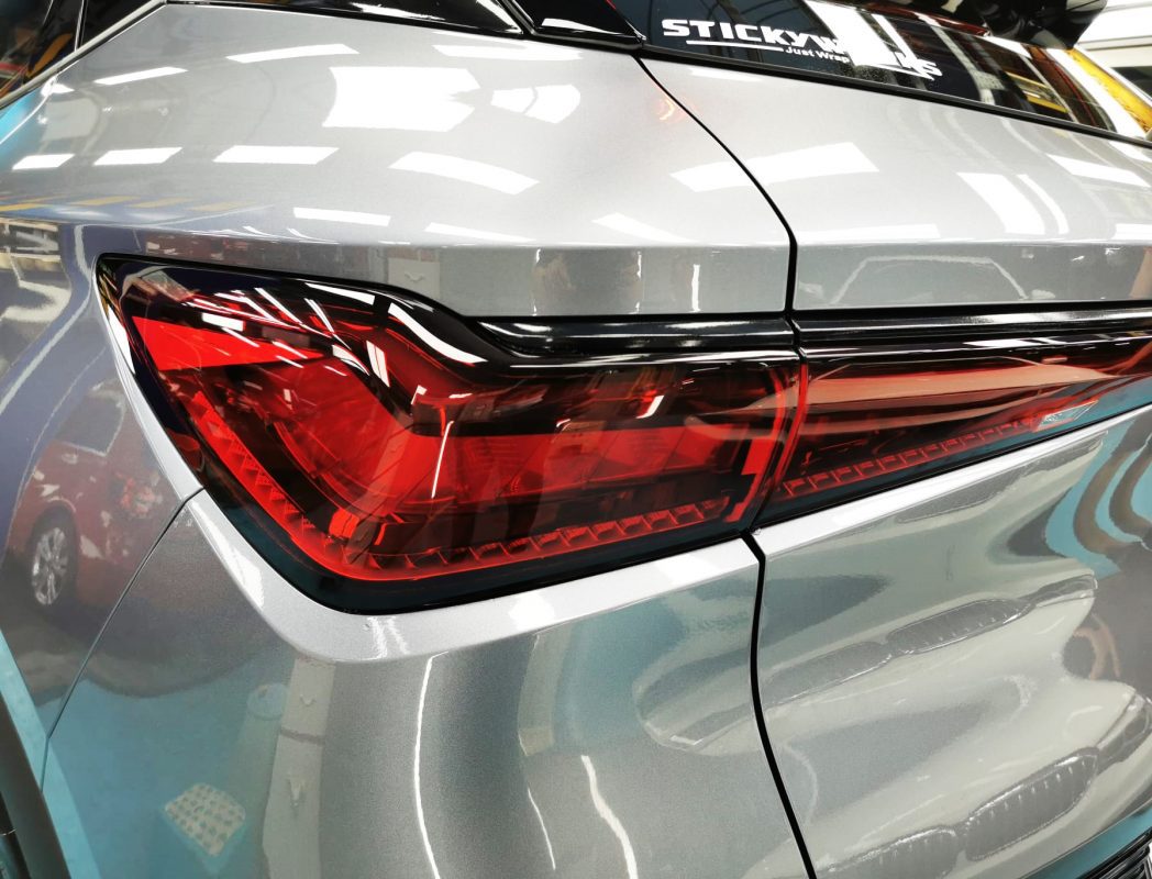 The coated bonnet of the BYD Atto 3 under workshop lighting.