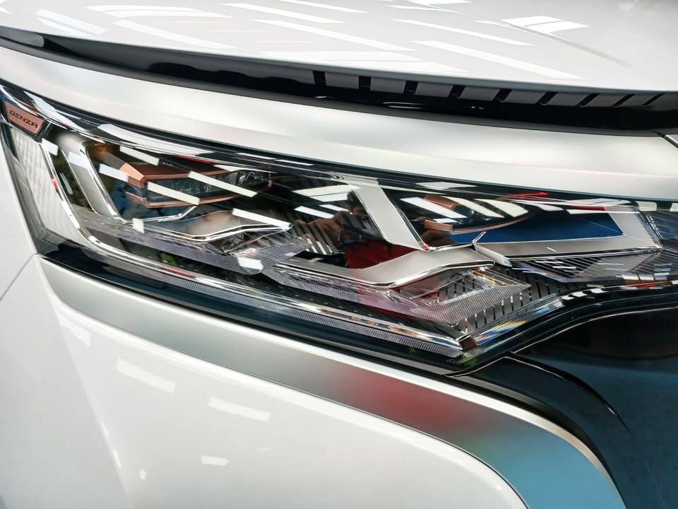 Close-up of the Denza D9 headlamp and white front panel.