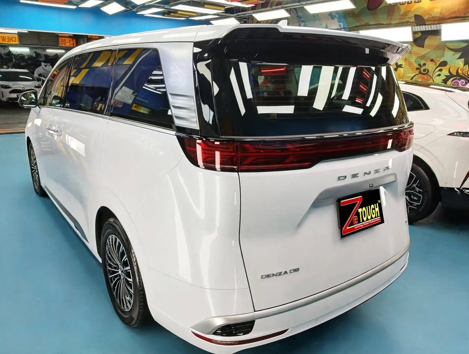 Rear view of the white Denza D9 with full-width tail lamp and ZeTough plate.