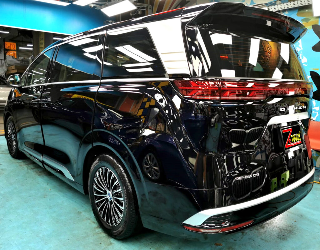 Rear quarter of the BYD Denza, glossy and protected.