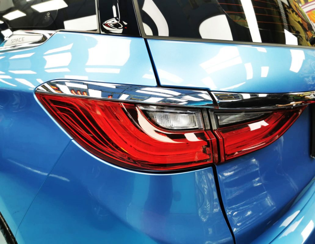The coated bonnet of the BYD E6 under workshop lighting.