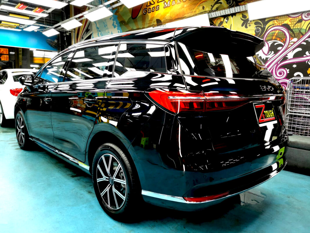 The coated bonnet of the BYD M6 under workshop lighting.