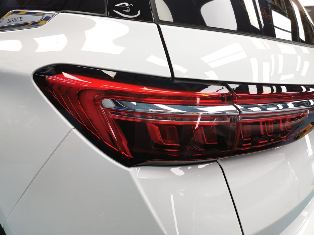 The coated bonnet of the BYD M6 under workshop lighting.