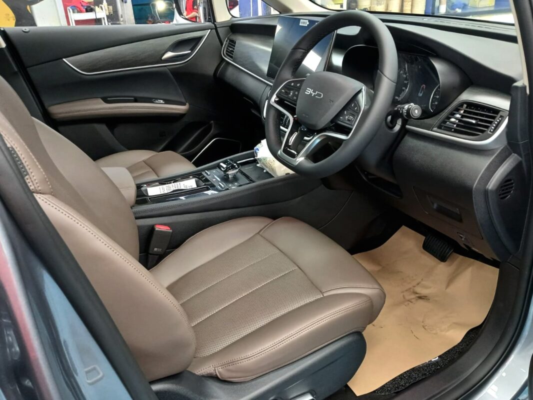 The BYD M6 parked in the workshop, freshly coated.