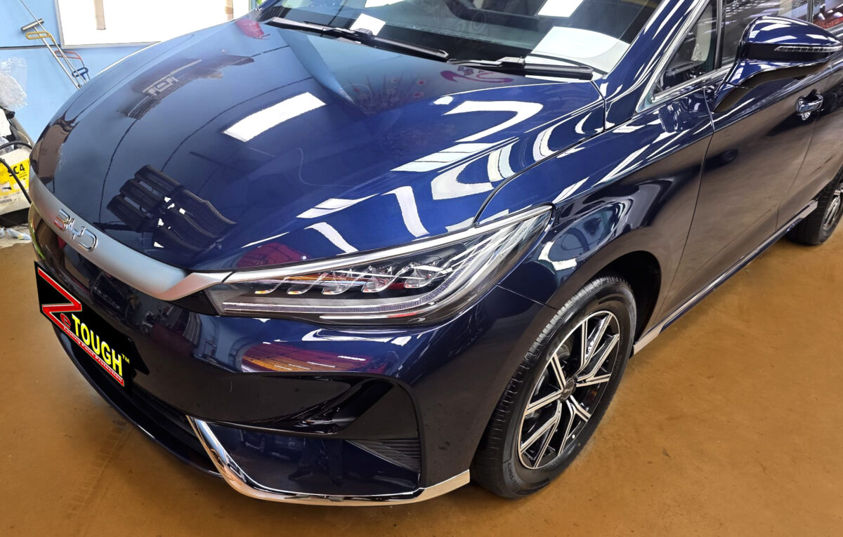The BYD M6's coated paintwork under workshop lighting.