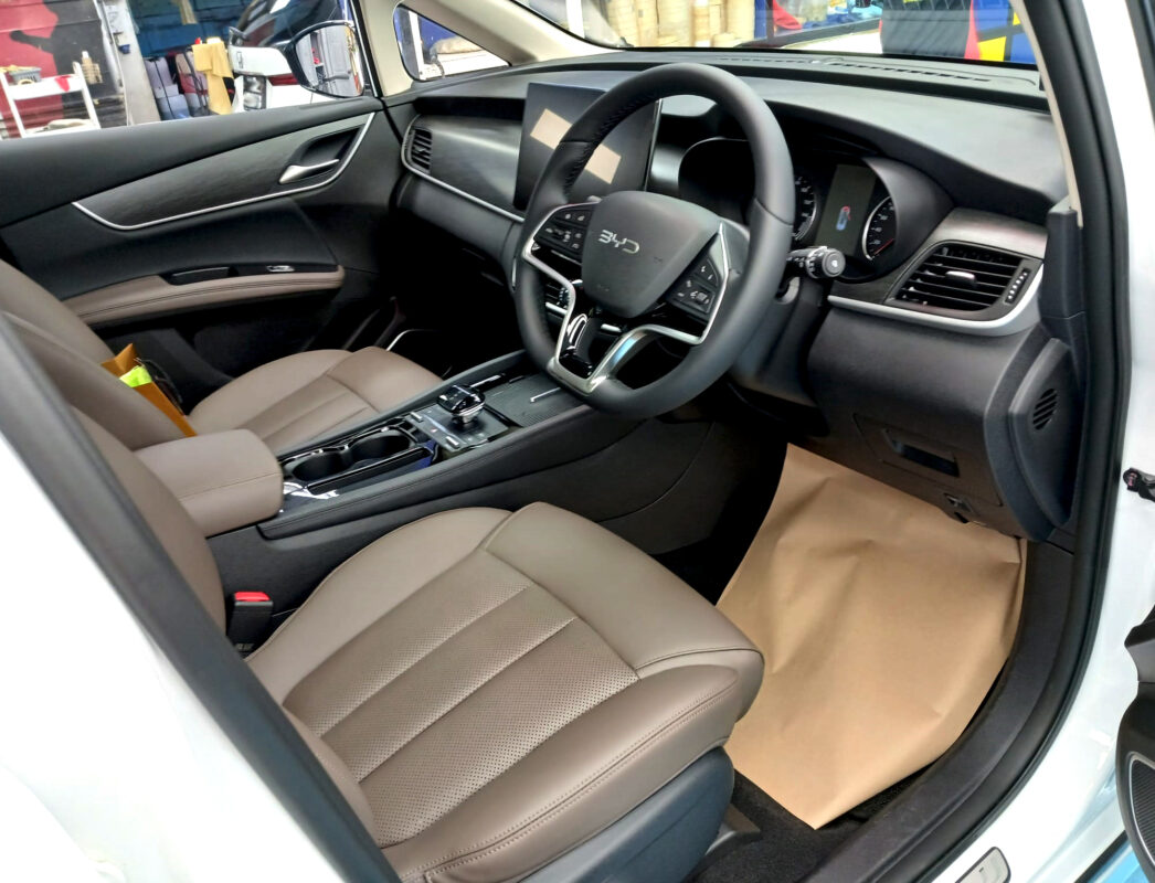 The BYD M6 parked in the workshop, freshly coated.