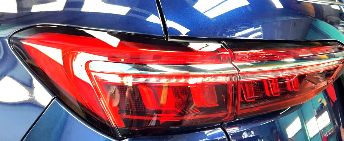 The coated bonnet of the BYD M6 under workshop lighting.