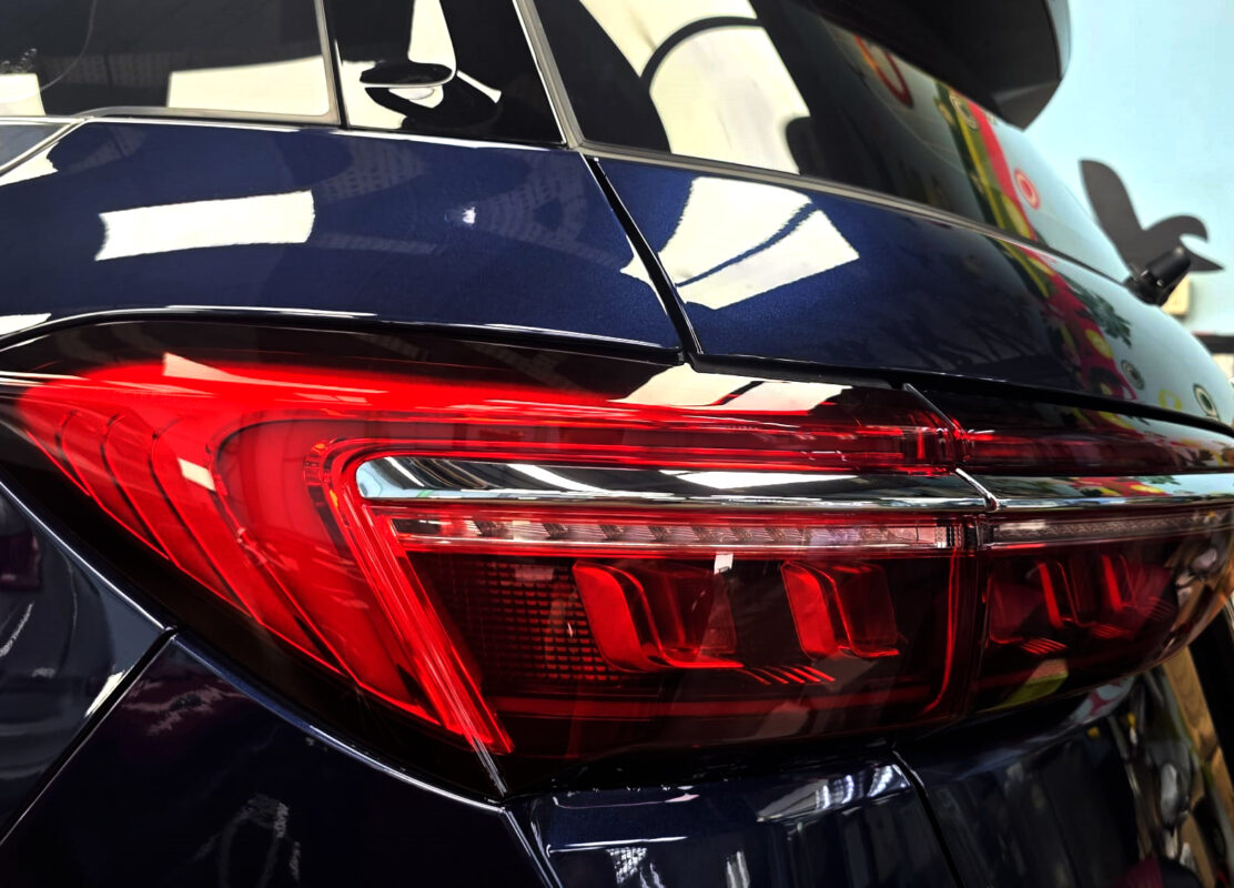The coated bonnet of the BYD M6 under workshop lighting.