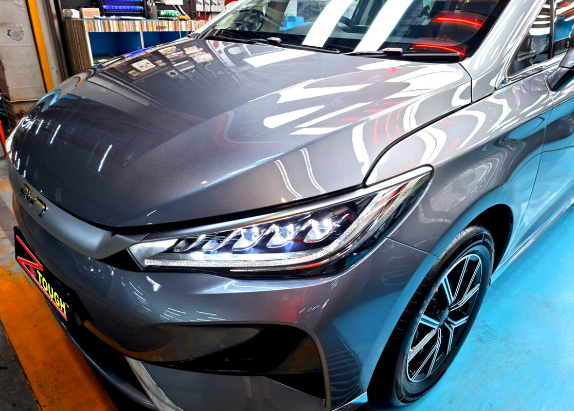 The BYD M6's coated paintwork under workshop lighting.