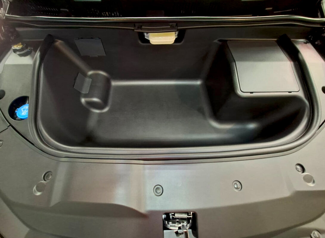 Reflections across the coated panels of the BYD M6.