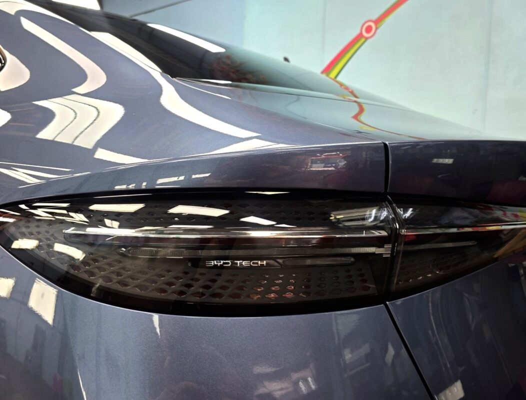 The coated bonnet of the BYD Seal under workshop lighting.