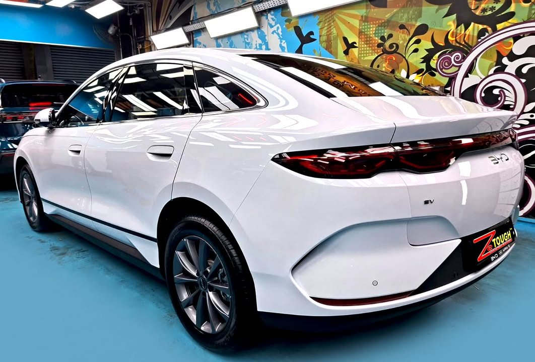 Rear three-quarter view of the white Seal 6 showing the full-width tail light.