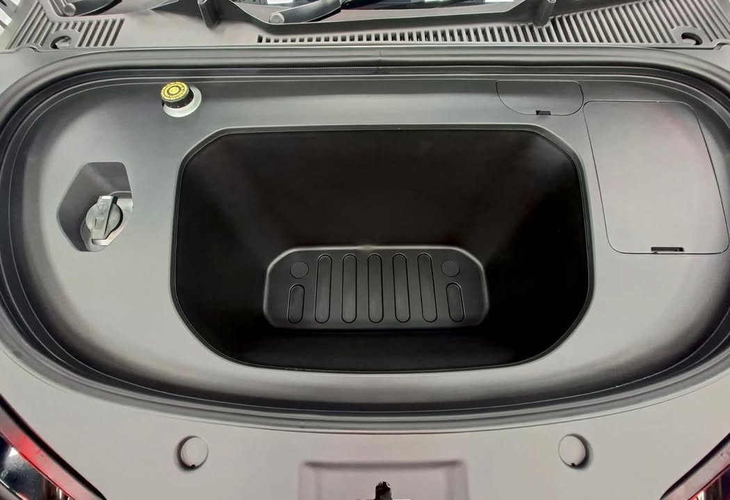 Clean front trunk with a black liner.