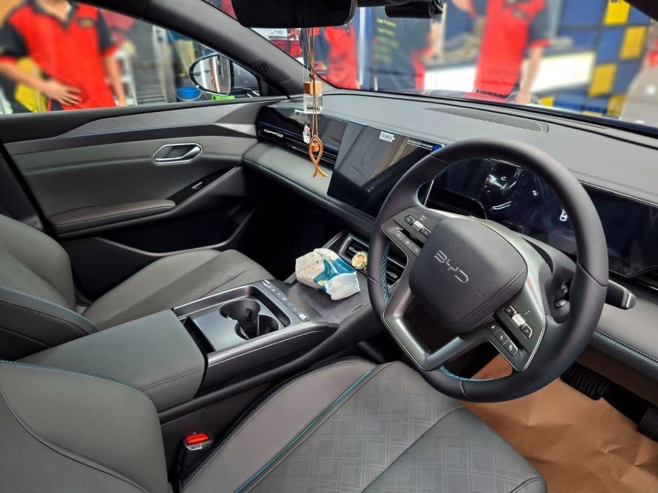 Interior view of the dashboard, steering wheel and centre console.