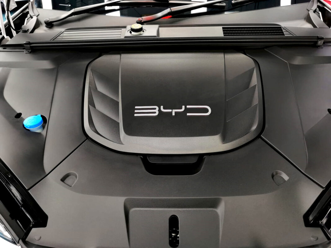 Reflections across the coated panels of the BYD Seal.