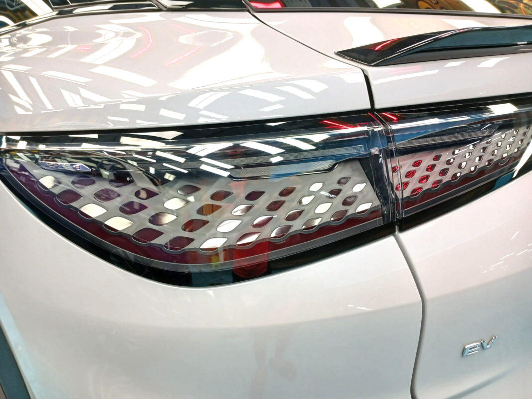 The coated bonnet of the BYD Sealion under workshop lighting.