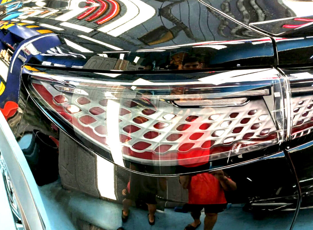 The coated bonnet of the BYD Sealion 7 under workshop lighting.