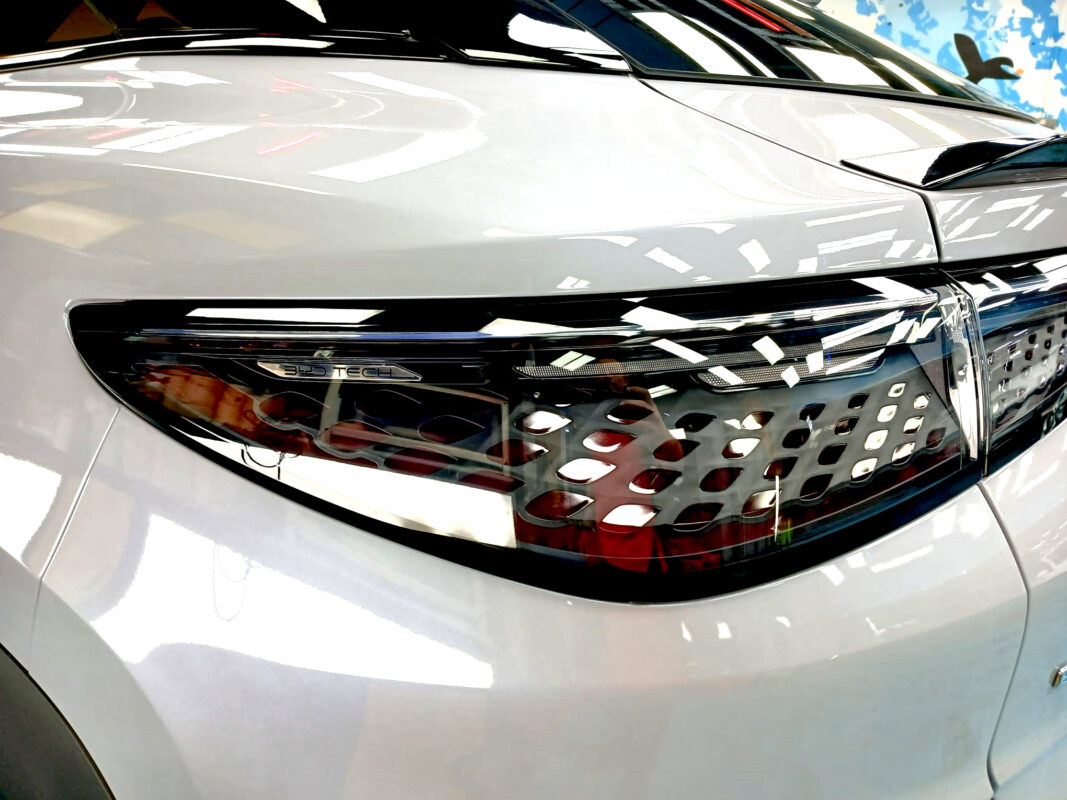 The coated bonnet of the BYD Sealion 7 under workshop lighting.