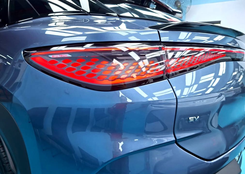 Close-up of the red tail light and EV badge on the rear quarter.