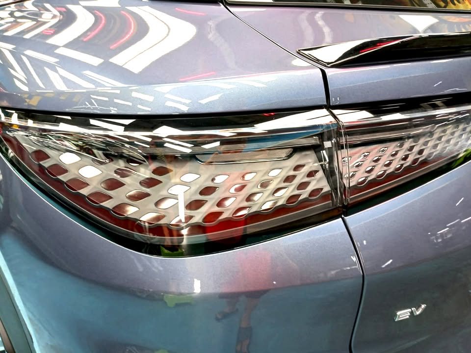 Close-up of the patterned tail lamp and EV badge on the tailgate.