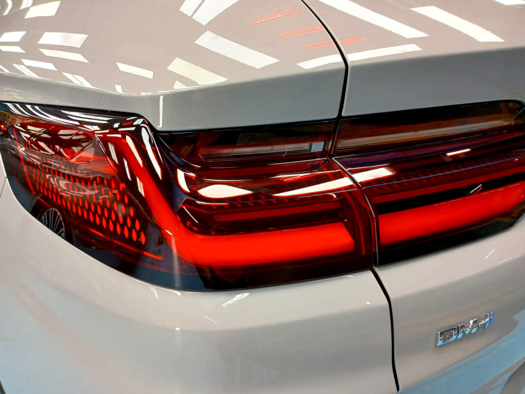 The coated bonnet of the BYD Sealion under workshop lighting.