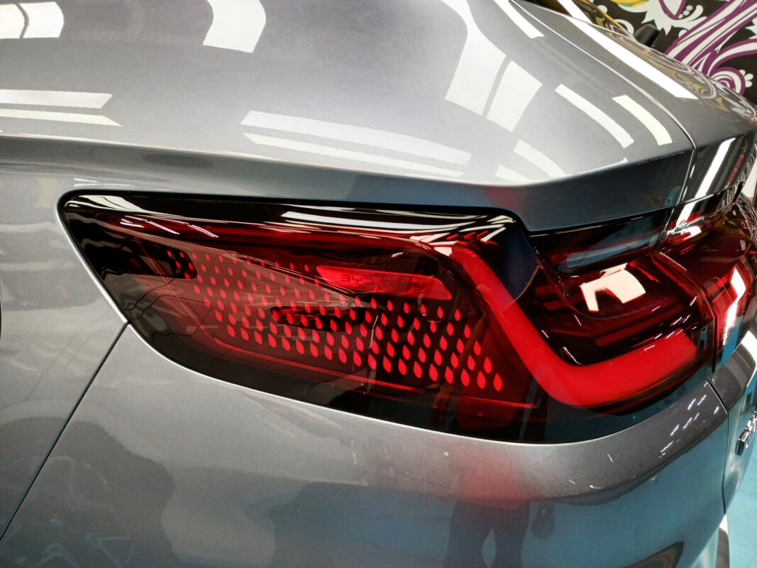 The coated bonnet of the BYD Sealion under workshop lighting.