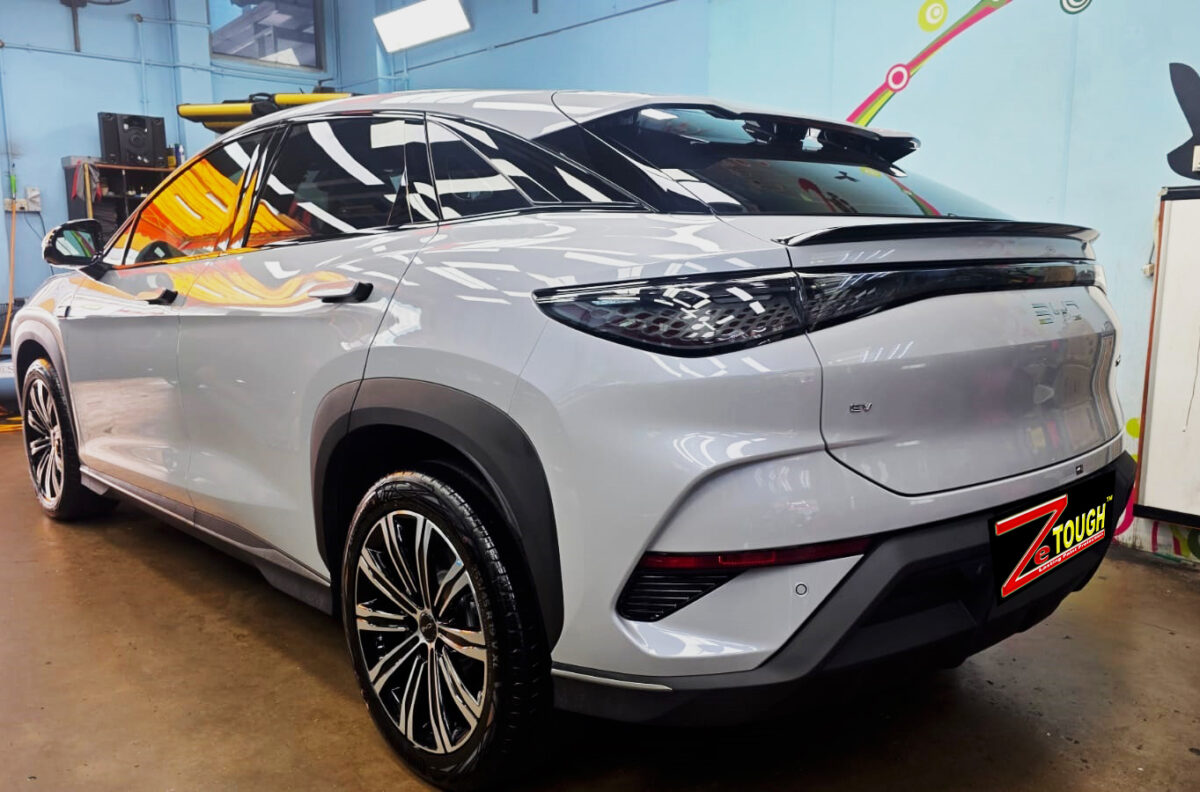 The coated bonnet of the BYD Sealion under workshop lighting.