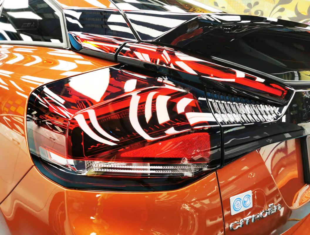 The coated bonnet of the Citroen C4 under workshop lighting.
