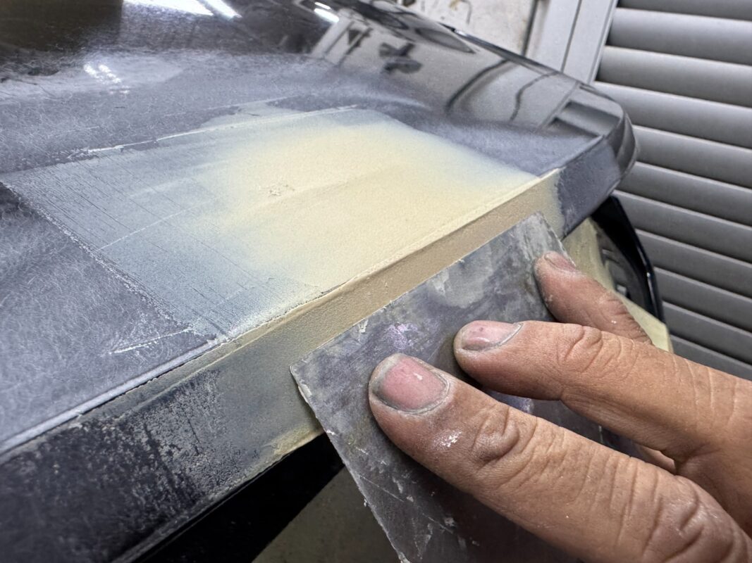 The body surface being checked and repaired for scratches and dents.