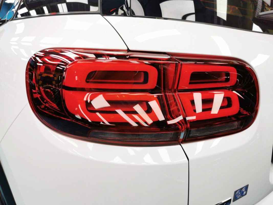 The coated bonnet of the Citroen C5 Aircross under workshop lighting.