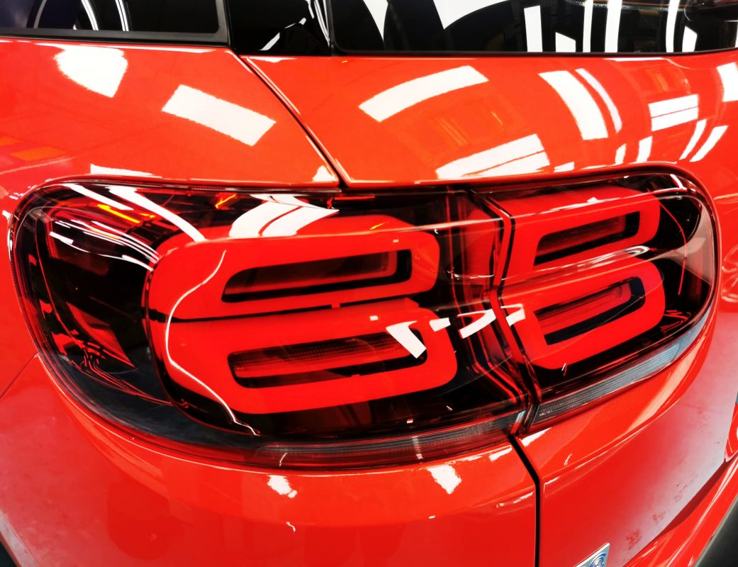 The coated bonnet of the Citroen C5 under workshop lighting.