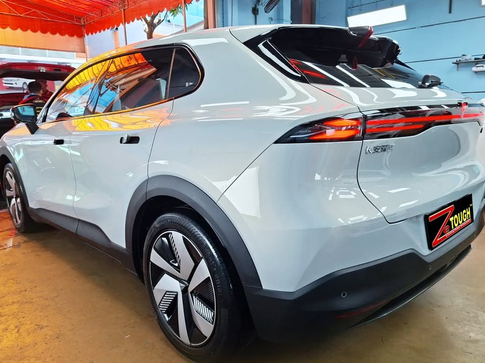 Light grey Deepal S05, rear three-quarter view, in the workshop.