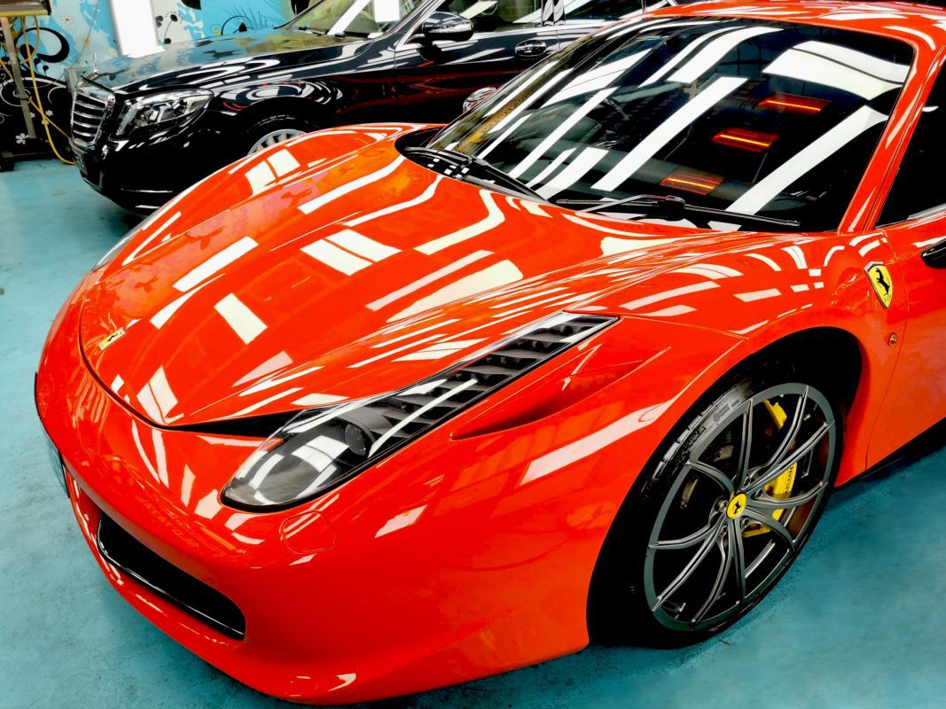The red Ferrari 458 from a side angle after the ceramic coating.