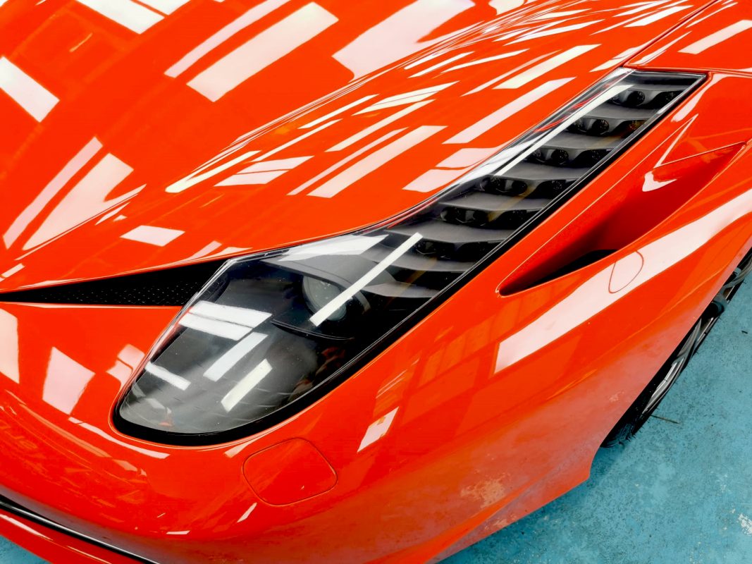 The Ferrari 458's coated paintwork showing clean reflections.