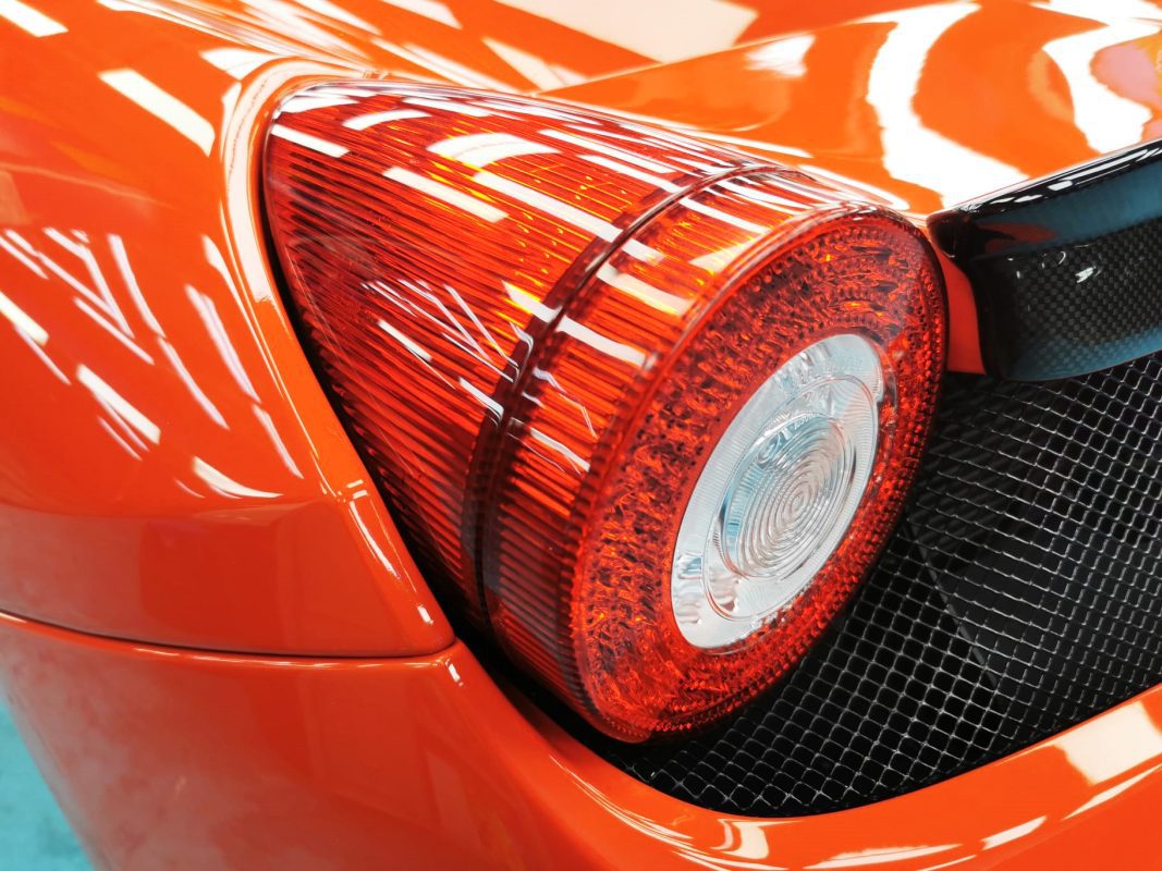 Rear quarter of the Ferrari 458, glossy and protected.
