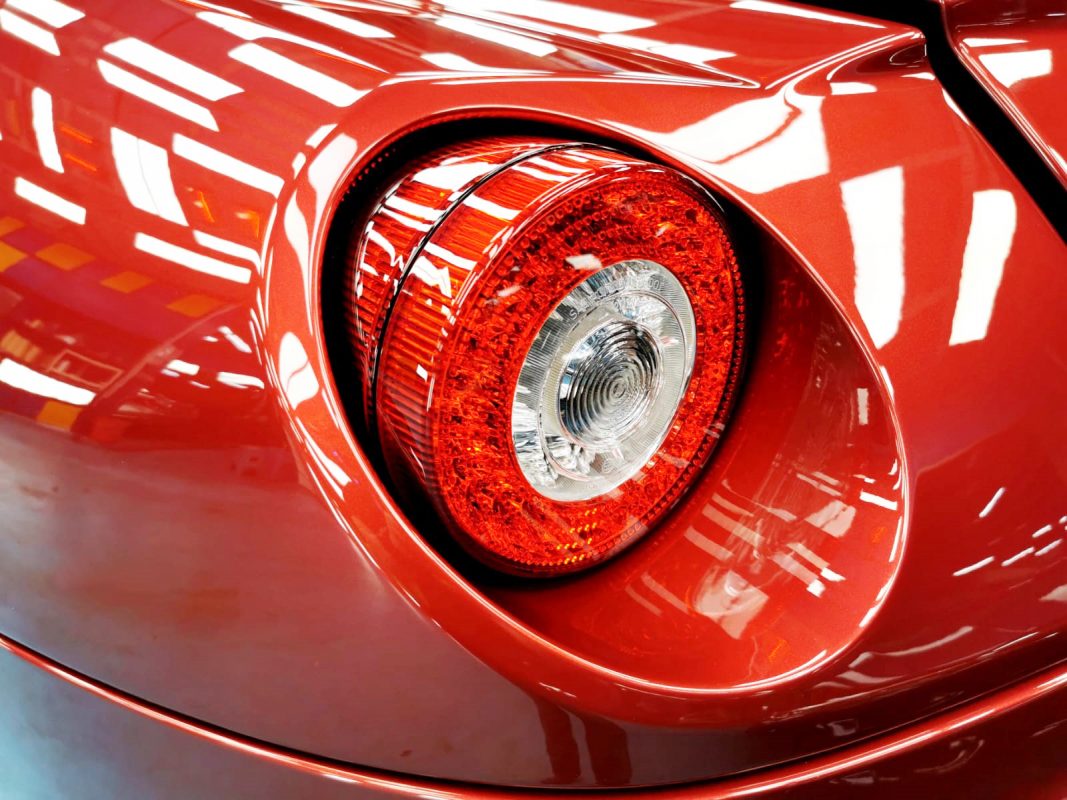 The coated bonnet of the Ferrari 599 under workshop lighting.