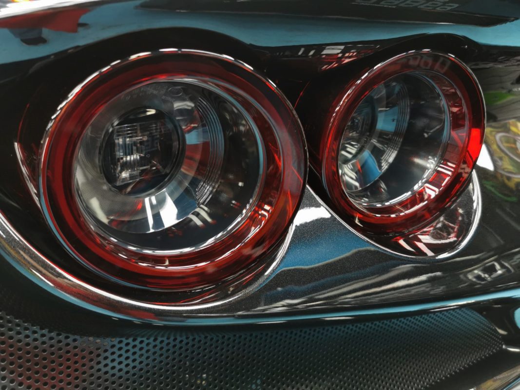 The coated rear deck of the Ferrari F8 under workshop lighting.