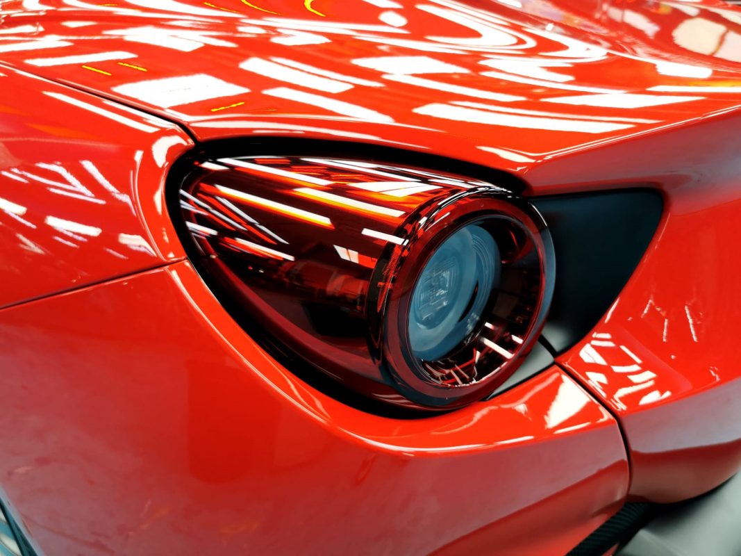 Coated bonnet of the Ferrari Portofino under workshop lighting.