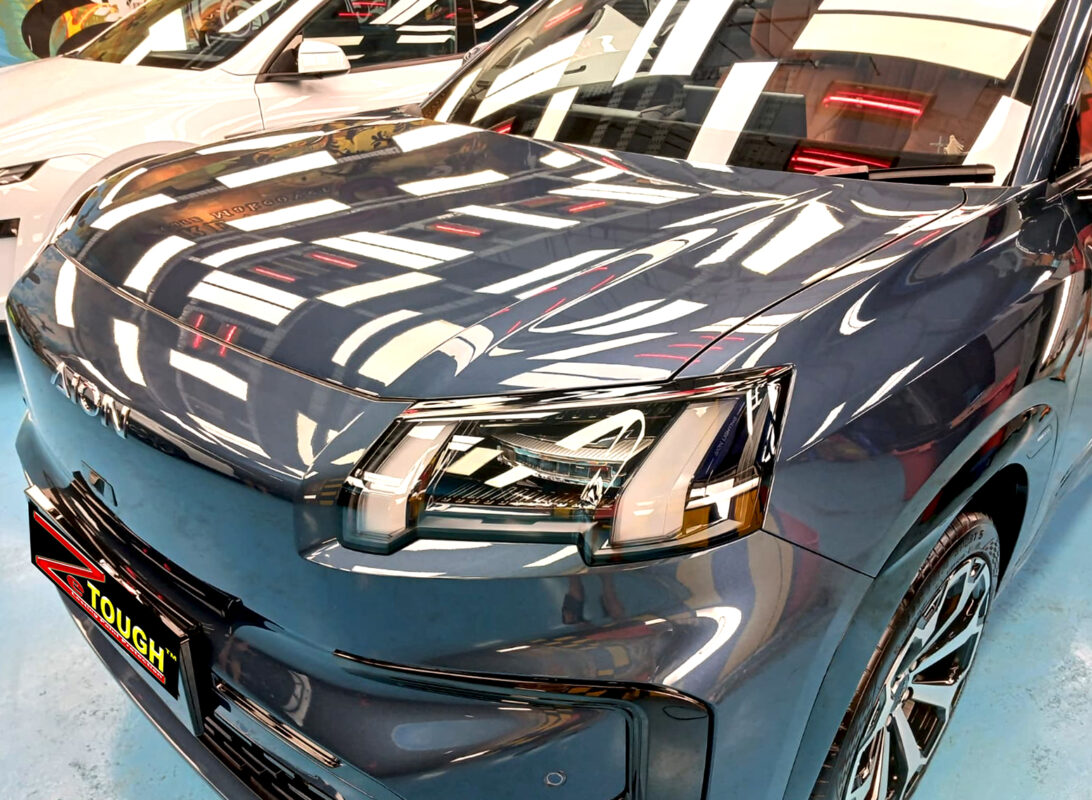 The GAC Aion V's coated paintwork under workshop lighting.