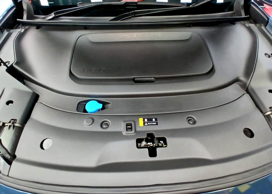 Reflections across the coated panels of the GAC Aion V.