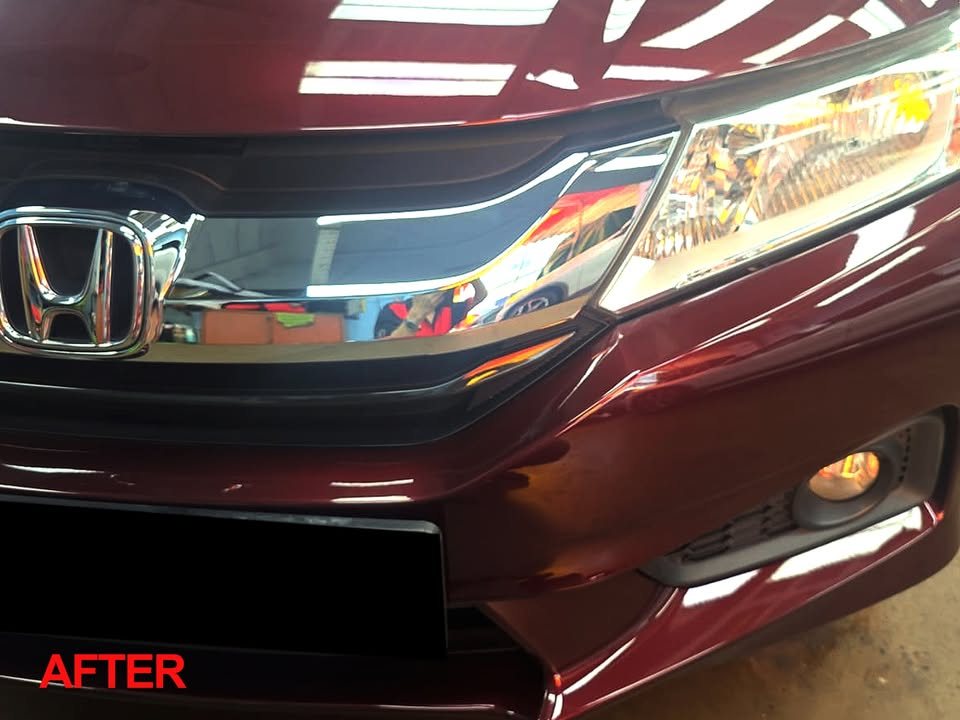 Front of the maroon Honda City with the grille and headlamp after the respray.
