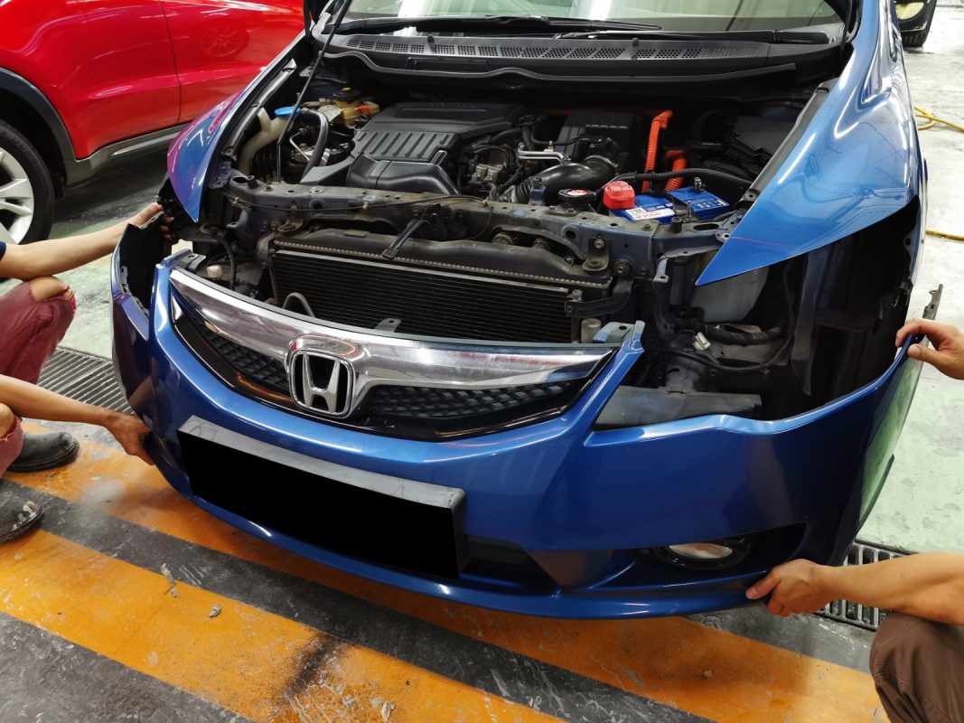The Honda Civic at an early stage of the job, with parts being dismantled.