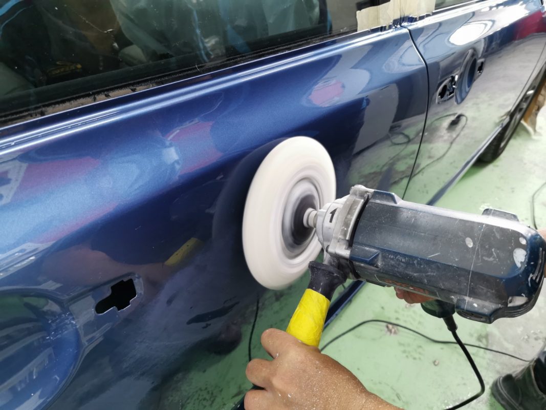 Buffing the fresh paint on the Civic to bring up the shine.