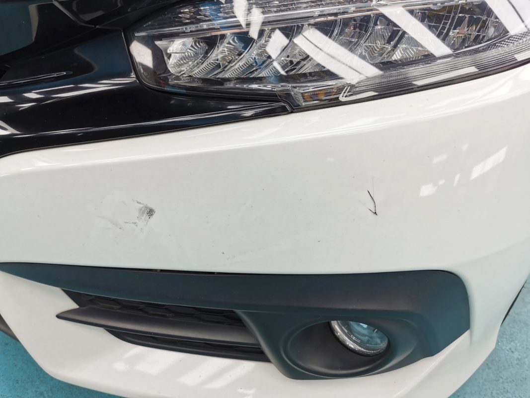 The Honda Civic at intake, showing chips and scratches on the body.