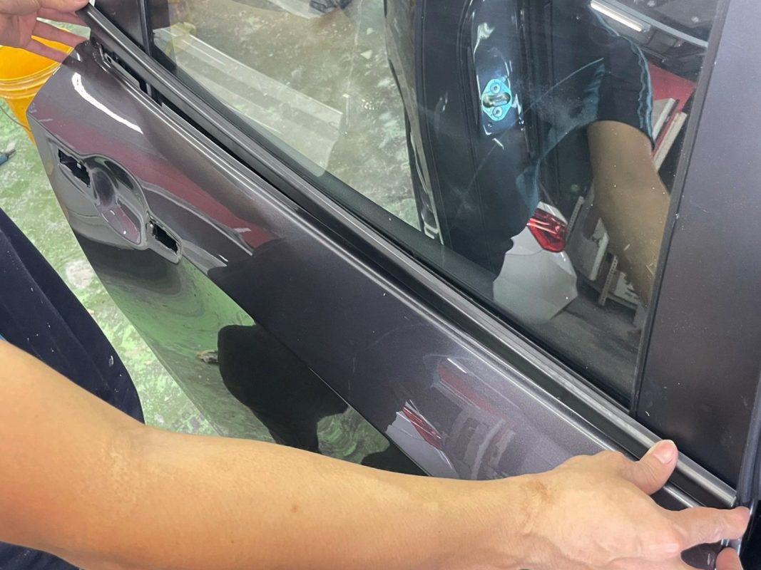 Previously removed car parts being refitted onto the Civic.