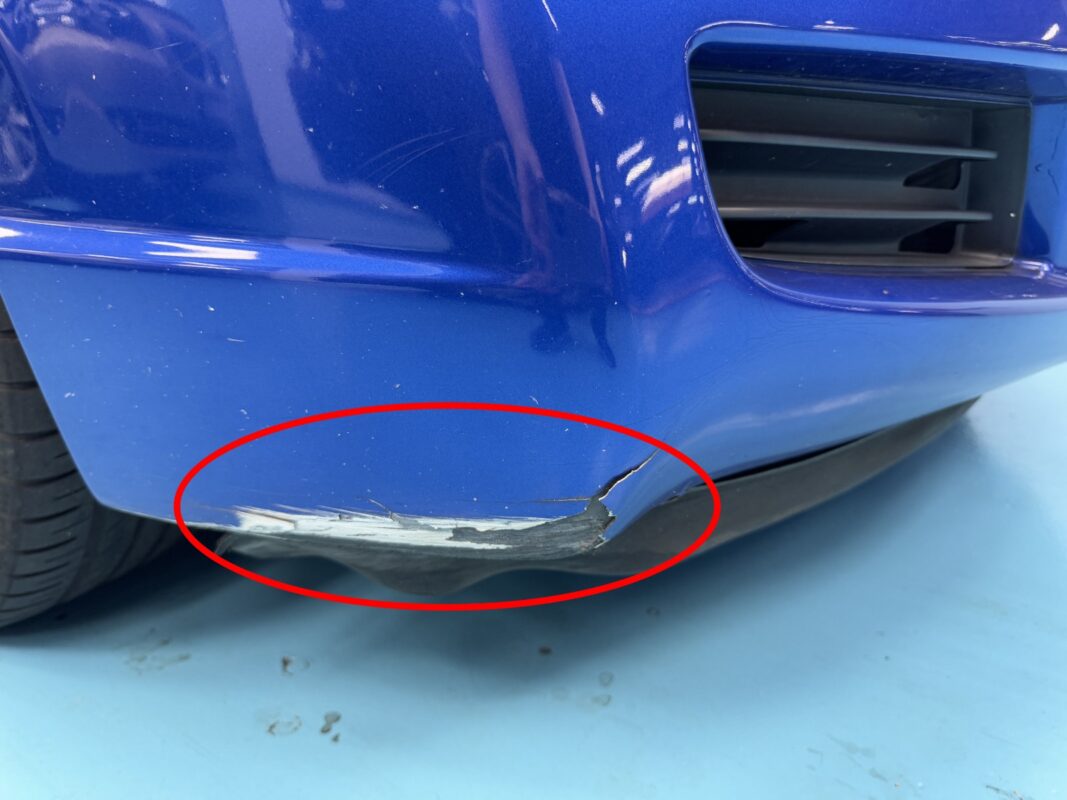 The Honda Civic from another angle at intake, showing the dull paintwork.