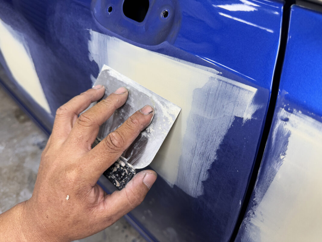 Paintwork flaws being repaired on the Honda Civic.