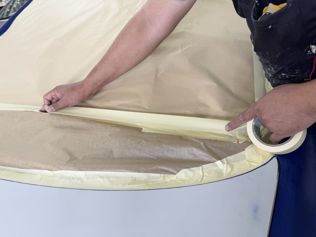 Non-painted surfaces being masked off on the Honda Civic.